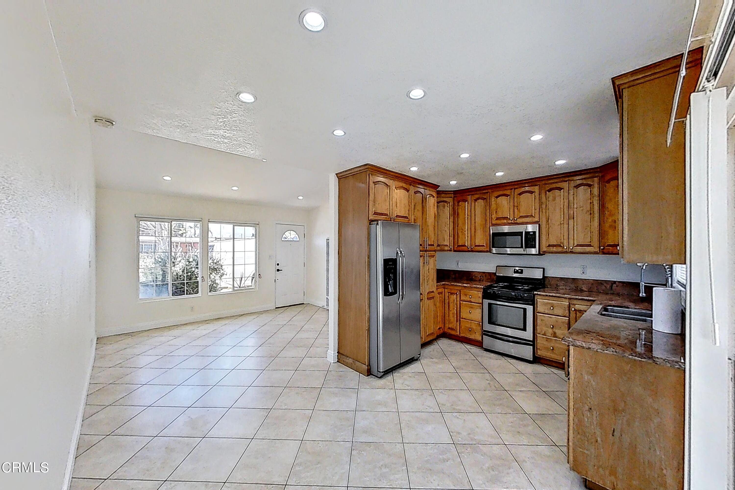 1830 Claremont Drive Oxnard, CA 93035 - Photo 15 of 36 a kitchen with stainless steel appliances granite countertop a refrigerator and a stove top oven