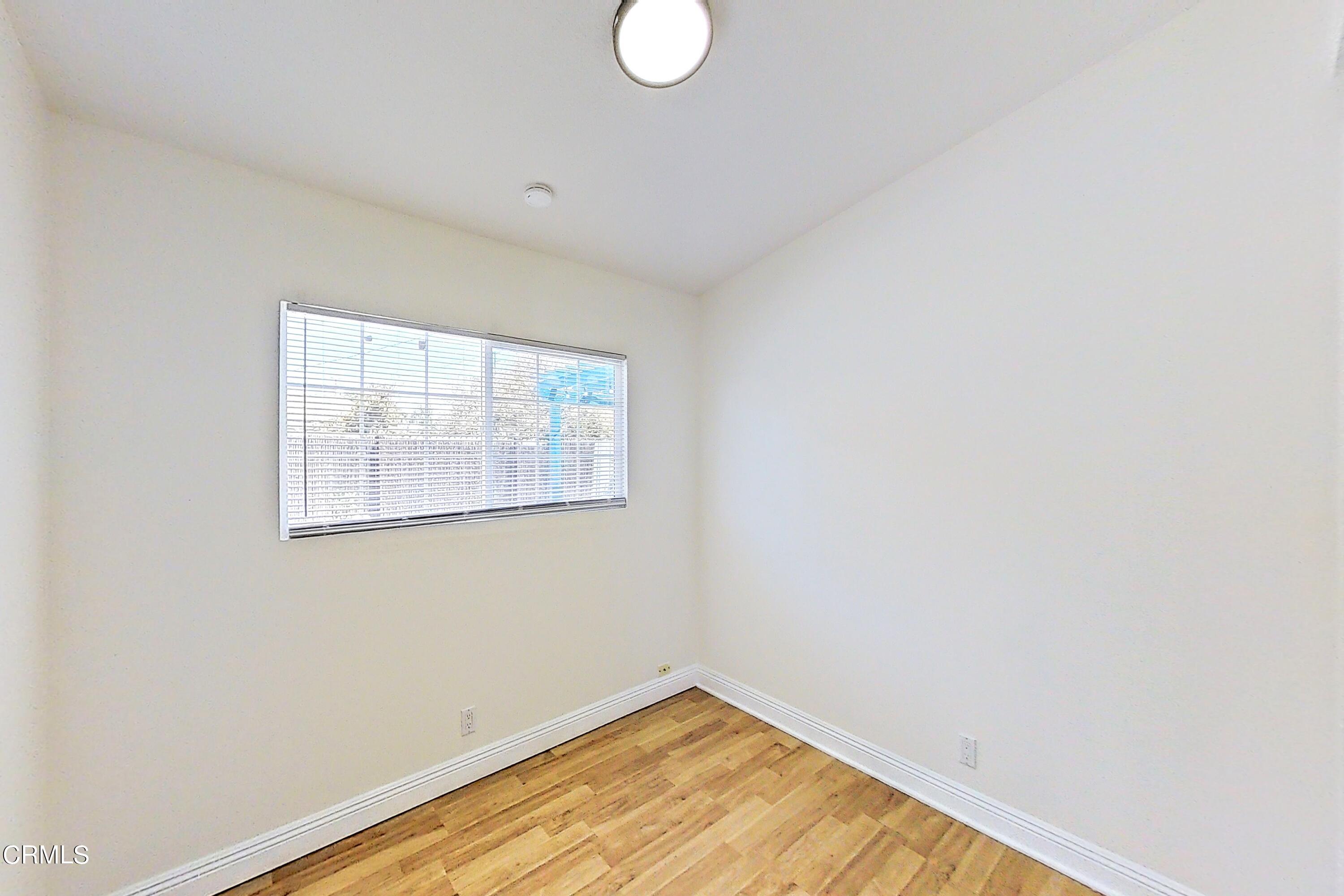 1830 Claremont Drive Oxnard, CA 93035 - Photo 17 of 36 an empty room with wooden floor and windows