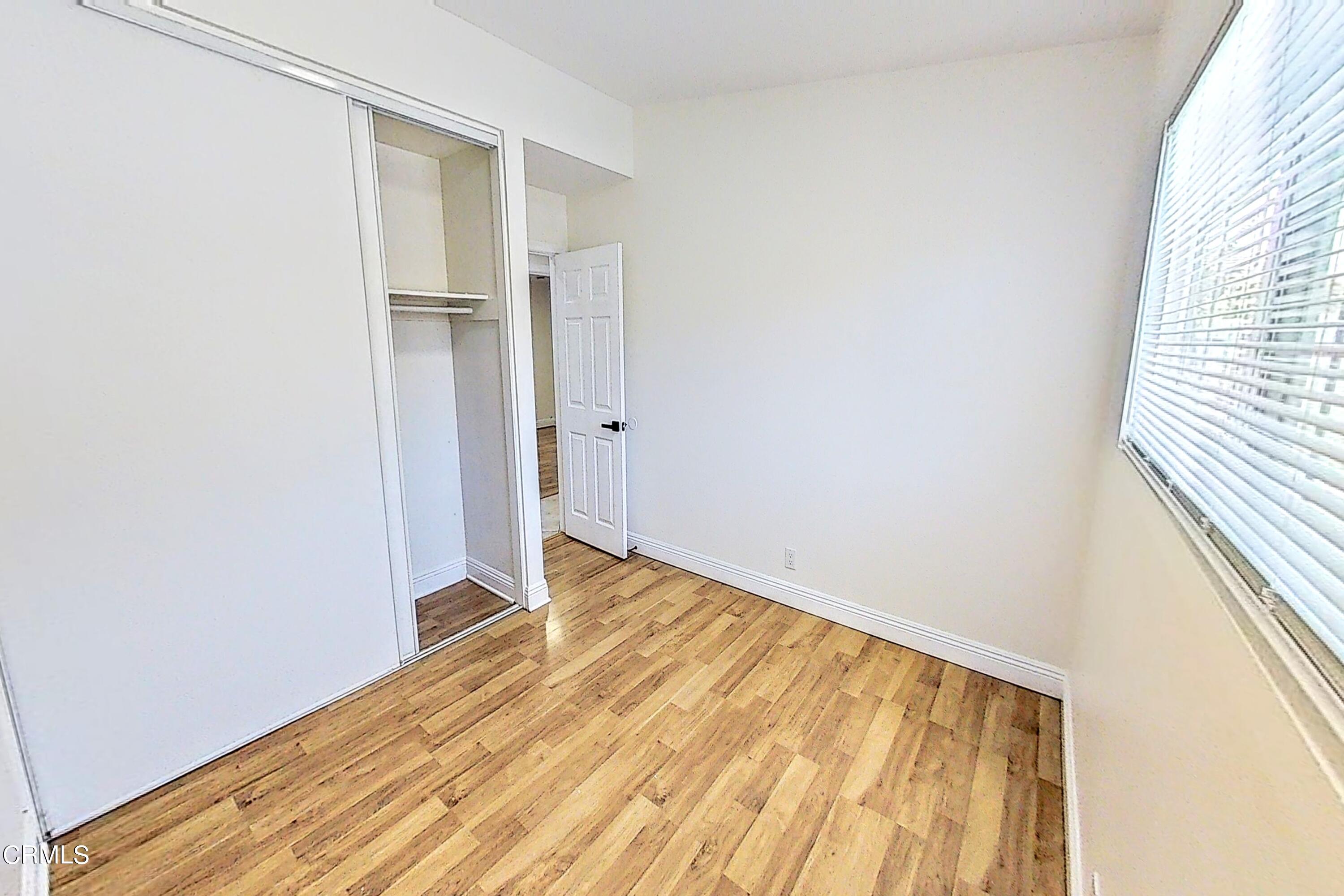 1830 Claremont Drive Oxnard, CA 93035 - Photo 18 of 36 a view of empty room with wooden floor and fan