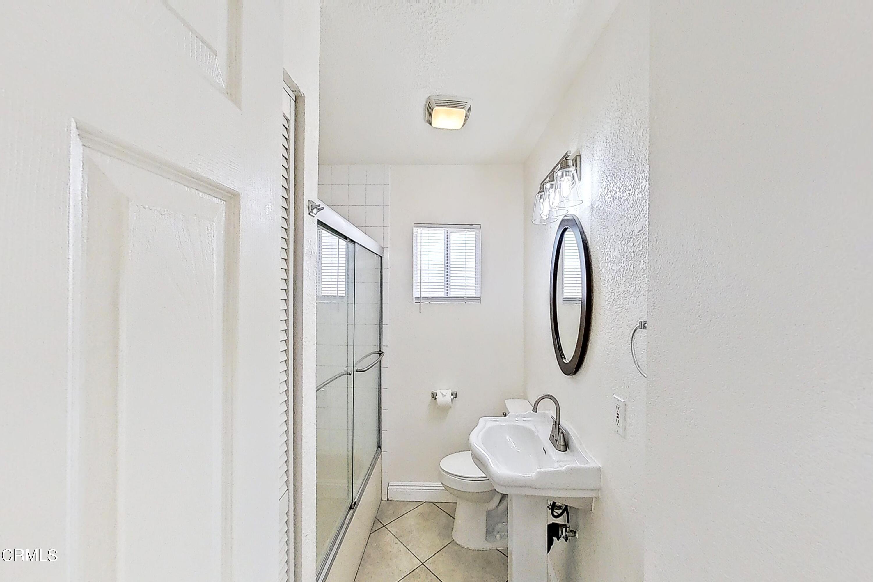 1830 Claremont Drive Oxnard, CA 93035 - Photo 19 of 36 a bathroom with a sink a mirror and a shower
