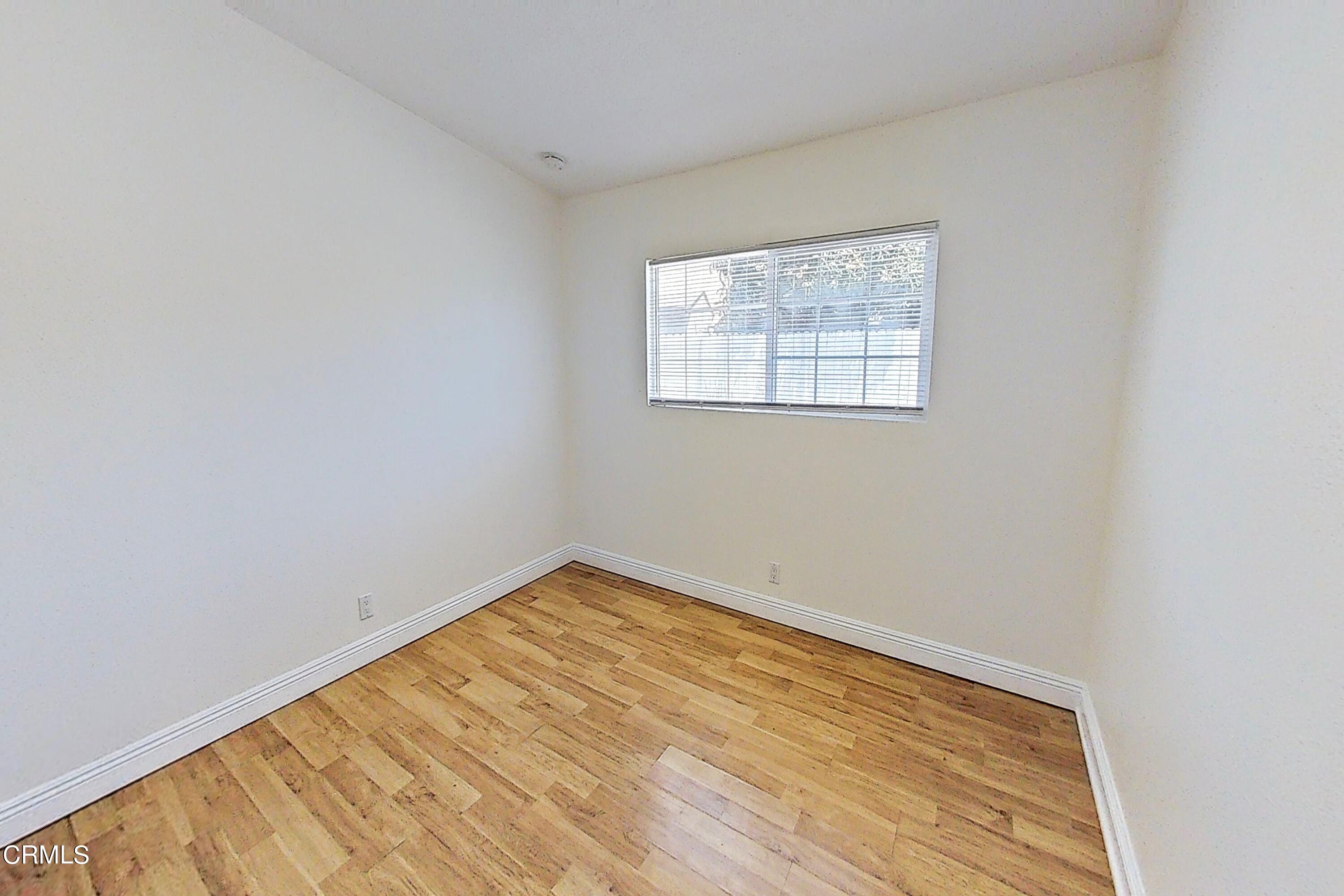 1830 Claremont Drive Oxnard, CA 93035 - Photo 20 of 36 an empty room with wooden floor and windows