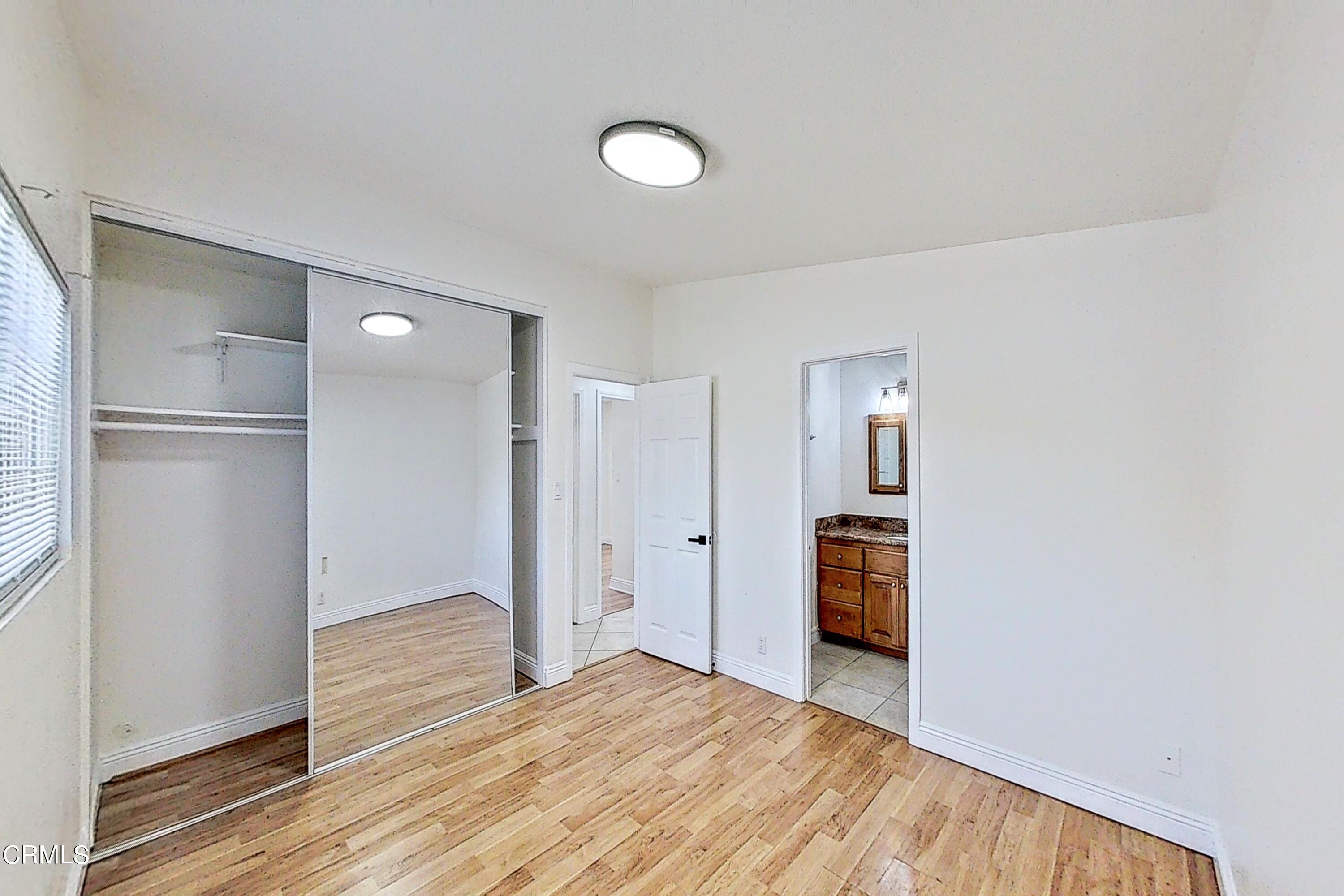 1830 Claremont Drive Oxnard, CA 93035 - Photo 22 of 36 a view of an empty room with wooden floor and closet