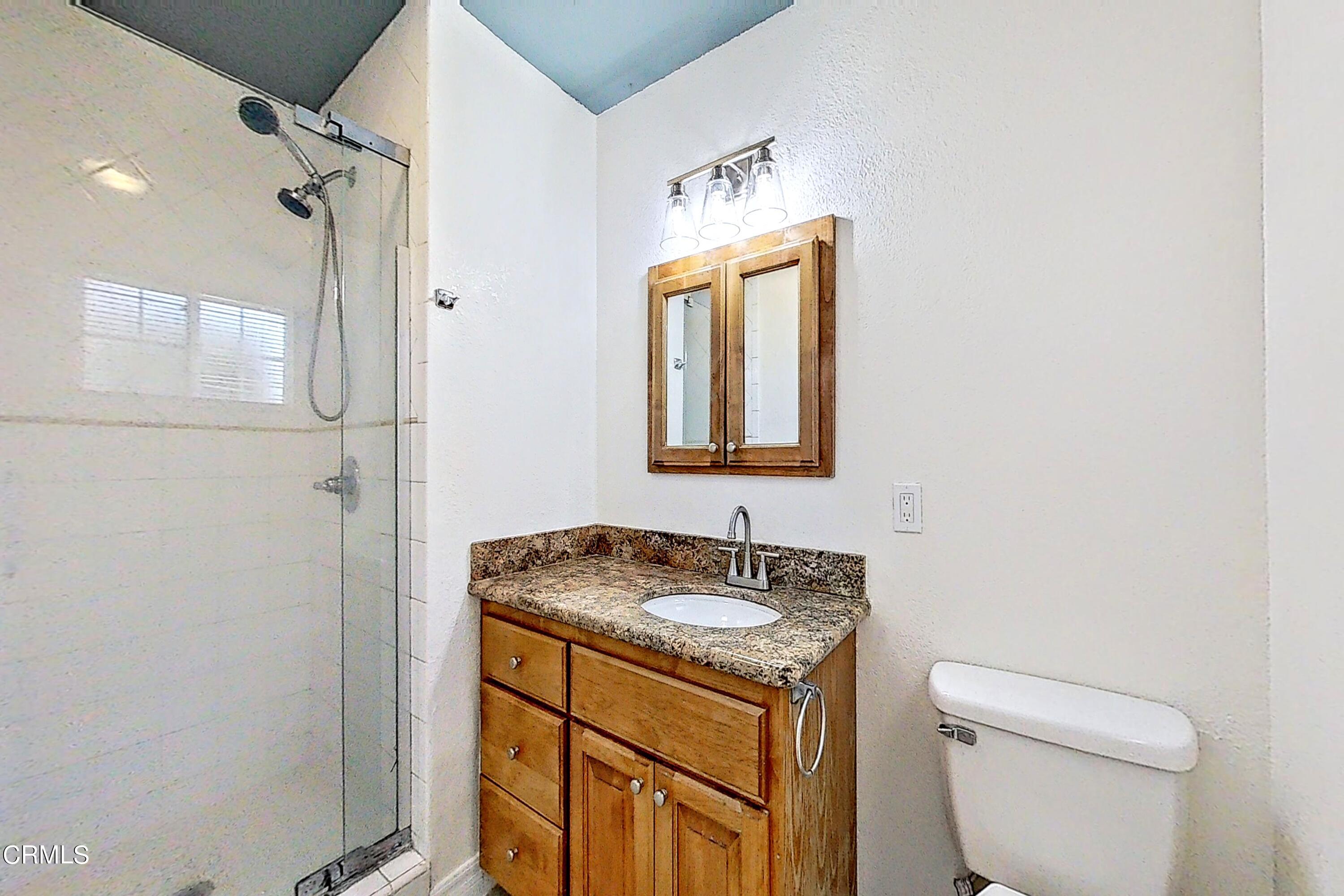1830 Claremont Drive Oxnard, CA 93035 - Photo 26 of 36 a bathroom with a granite countertop sink toilet and shower