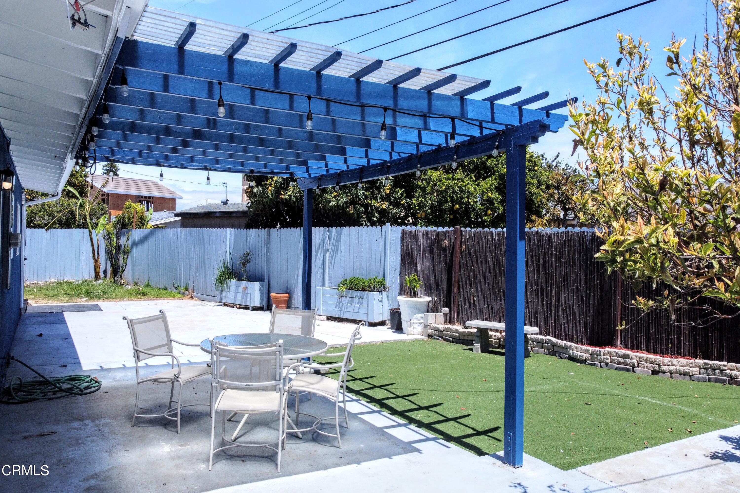 1830 Claremont Drive Oxnard, CA 93035 - Photo 27 of 36 a patio with a table and chairs with wooden fence