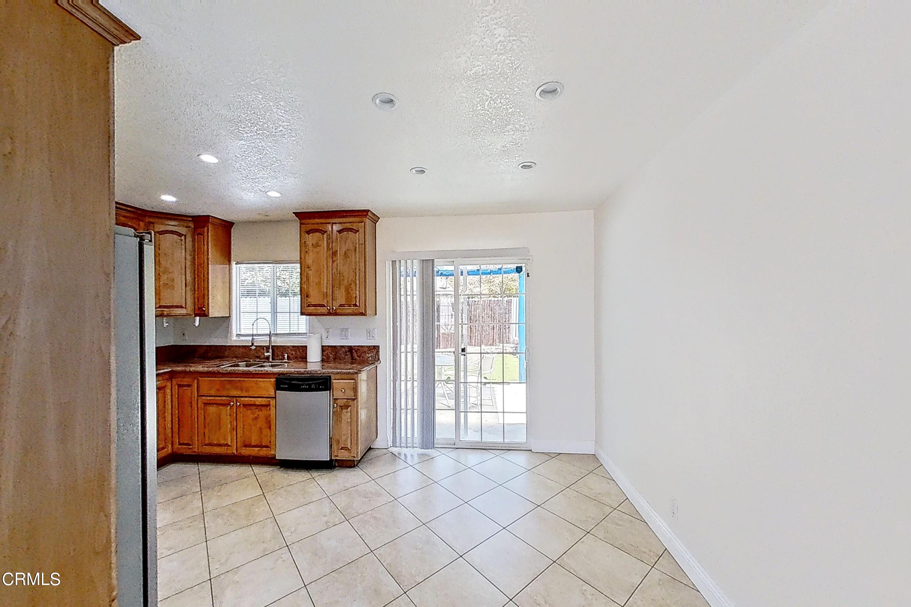 1830 Claremont Drive Oxnard, CA 93035 - Photo 8 of 36 a kitchen with stainless steel appliances granite countertop a stove and a refrigerator
