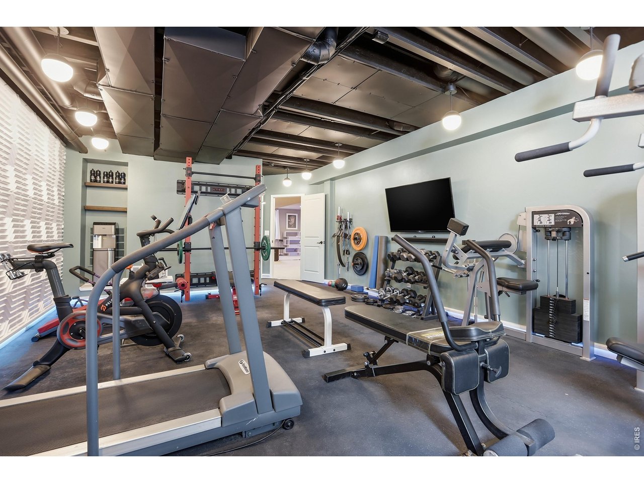 714 Skywalker Point Lafayette, CO 80026 - Photo 33 of 44 Large Storage Room converted to an amazing home gym. Most equipment optionally included (except Peloton, some weights)