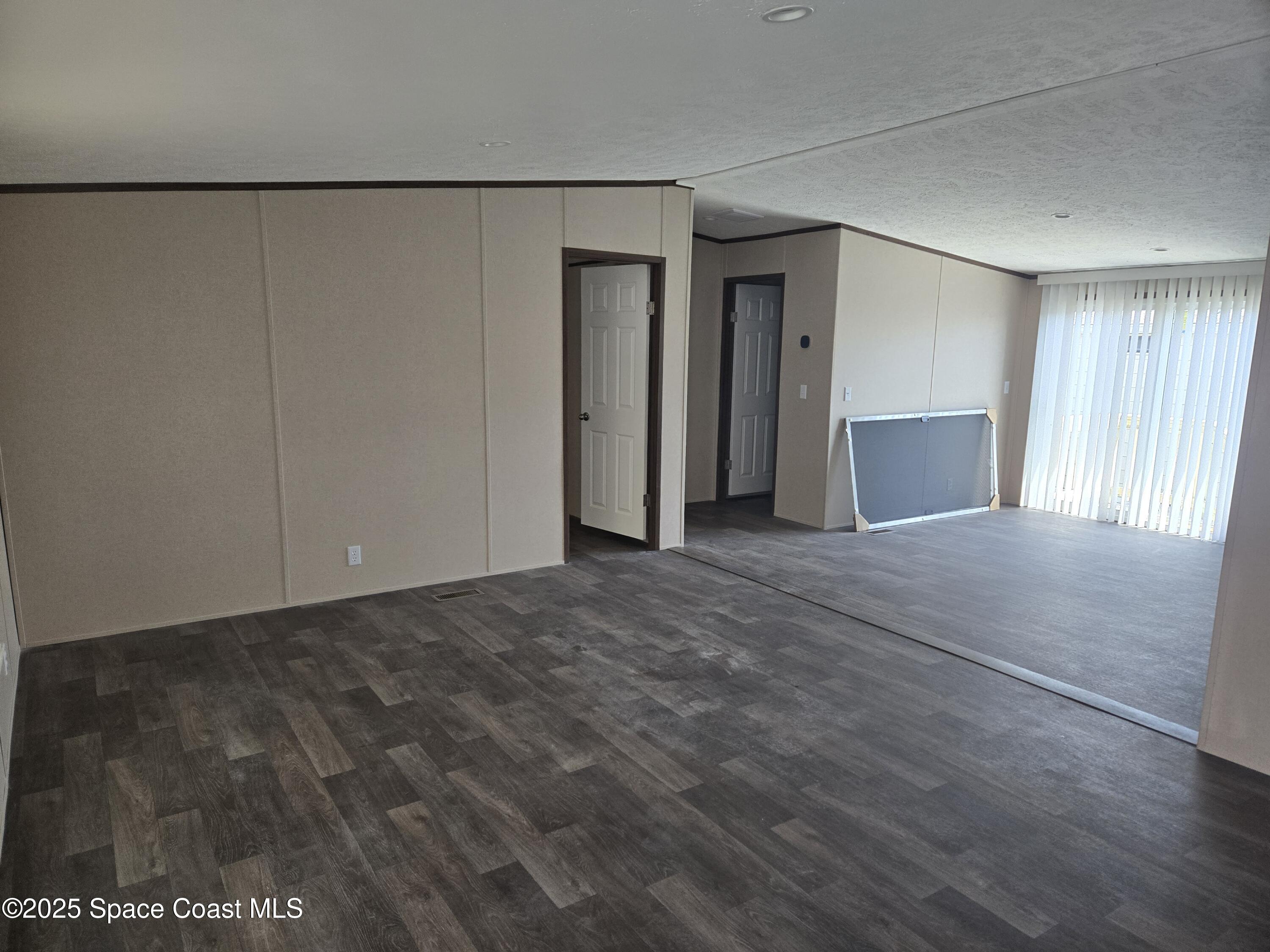 2534 Amberly Road Northeast Palm Bay, FL 32905 - Photo 2 of 5 a view of a livingroom with an empty space
