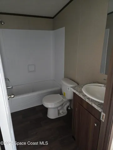 a white toilet sitting next to a shower