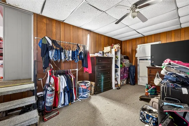 a view of walk in closet with clothes