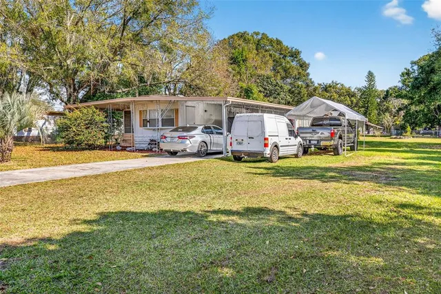 a front view of a house with swimming pool and porch with furniture