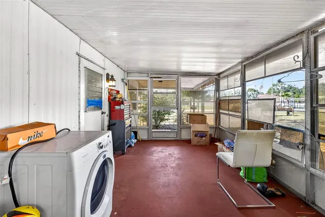 a living room with furniture and a floor to ceiling window