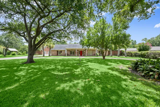 a house view with a sitting space and garden