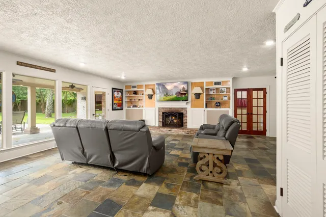 a living room with furniture and a fireplace