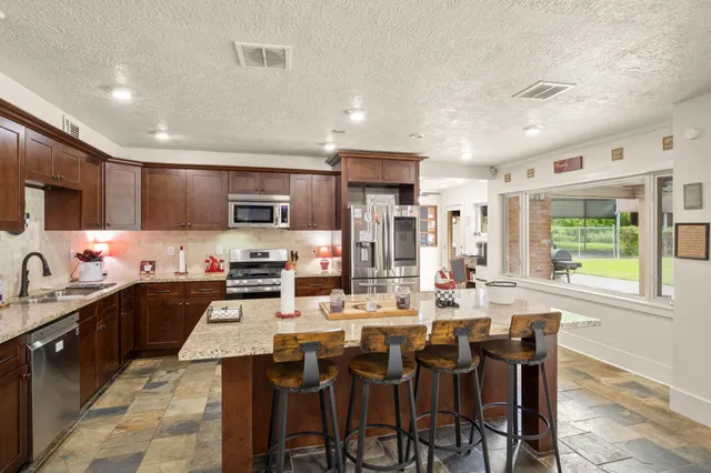 a large kitchen with a table and chairs