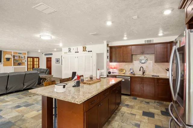 a kitchen with granite countertop a sink and stove
