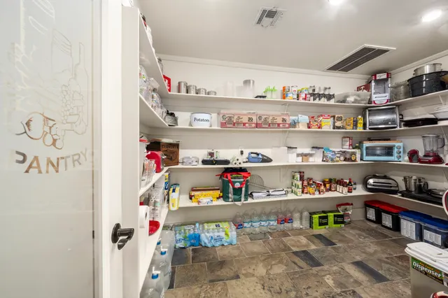 a store room with lots of clutter and refrigerator