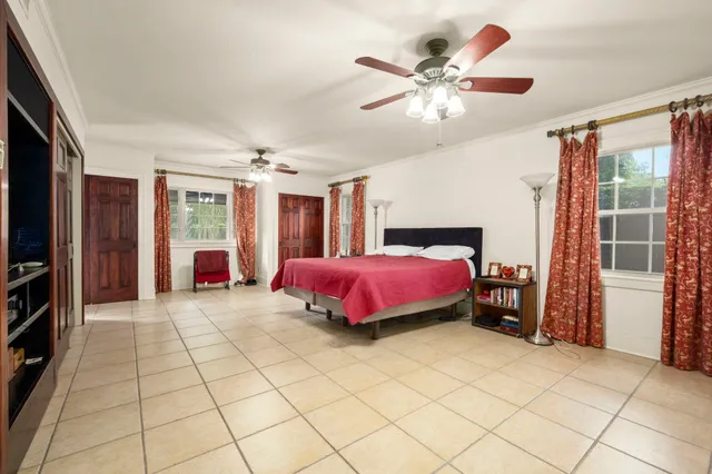 a spacious bedroom with a bed and window