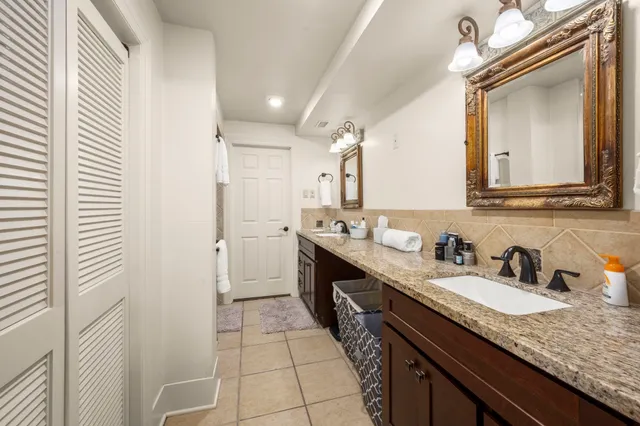 a bathroom with a double vanity sink and a mirror