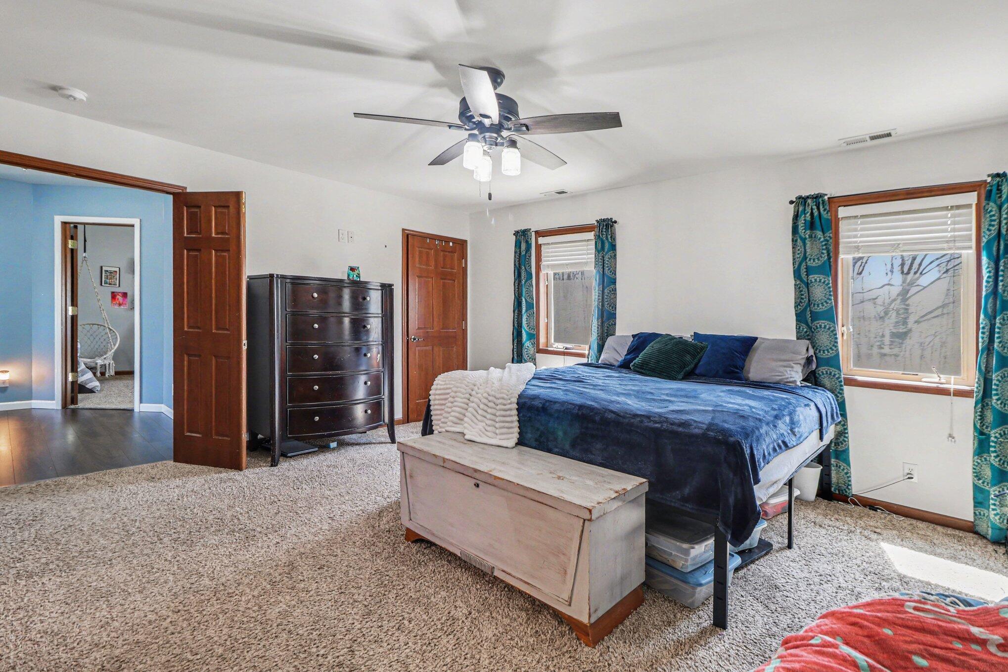 190 East Mekeland Road Chesterton, IN 46304 - Photo 13 of 29 a spacious bedroom with a bed and ceiling fan