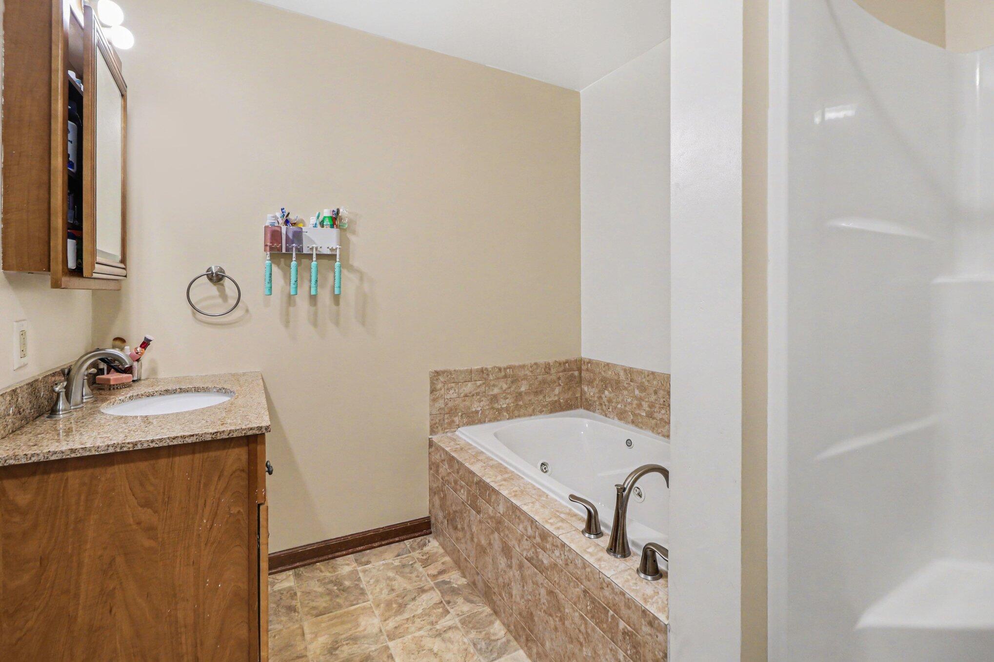 190 East Mekeland Road Chesterton, IN 46304 - Photo 14 of 29 a bathroom with a tub sink and mirror