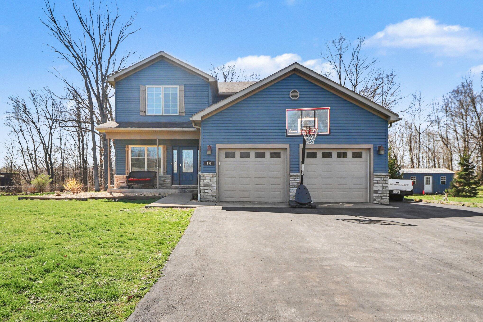190 East Mekeland Road Chesterton, IN 46304 - Photo 3 of 29 a view of a house with a yard and garage