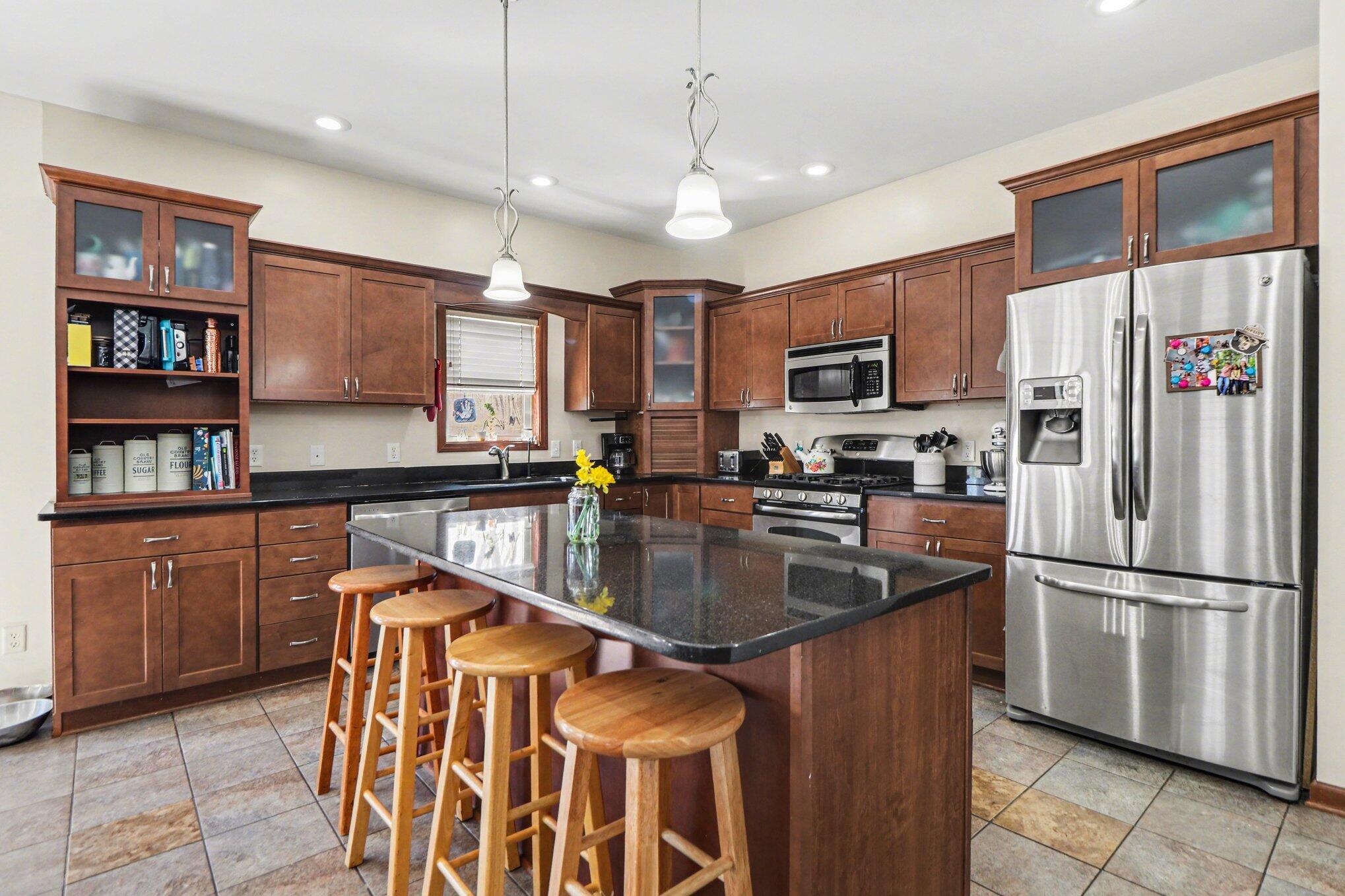 190 East Mekeland Road Chesterton, IN 46304 - Photo 7 of 29 a kitchen with stainless steel appliances granite countertop a refrigerator a oven a sink a stove and a refrigerator