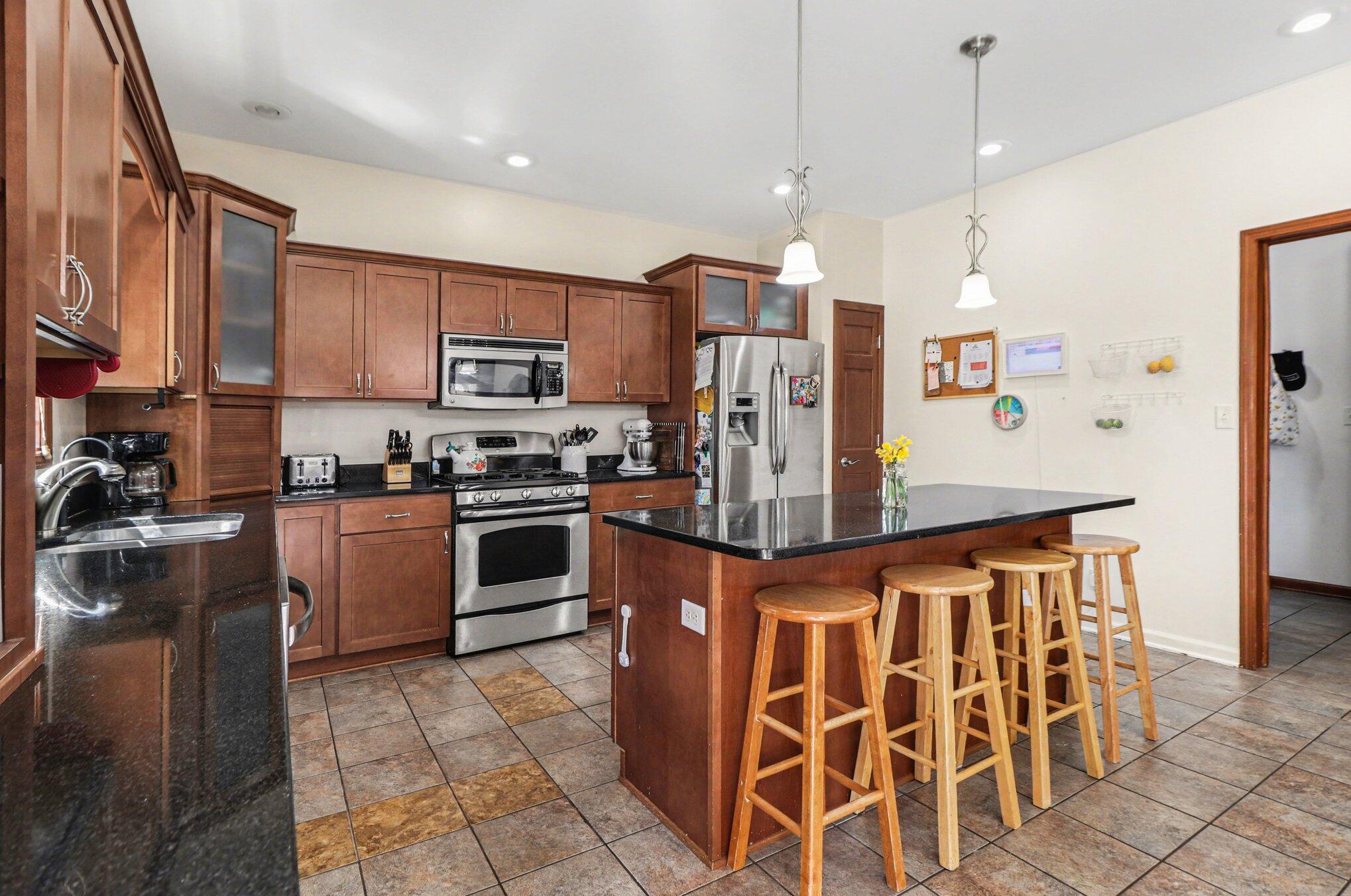 190 East Mekeland Road Chesterton, IN 46304 - Photo 8 of 29 a kitchen with stainless steel appliances granite countertop a stove a sink and a refrigerator
