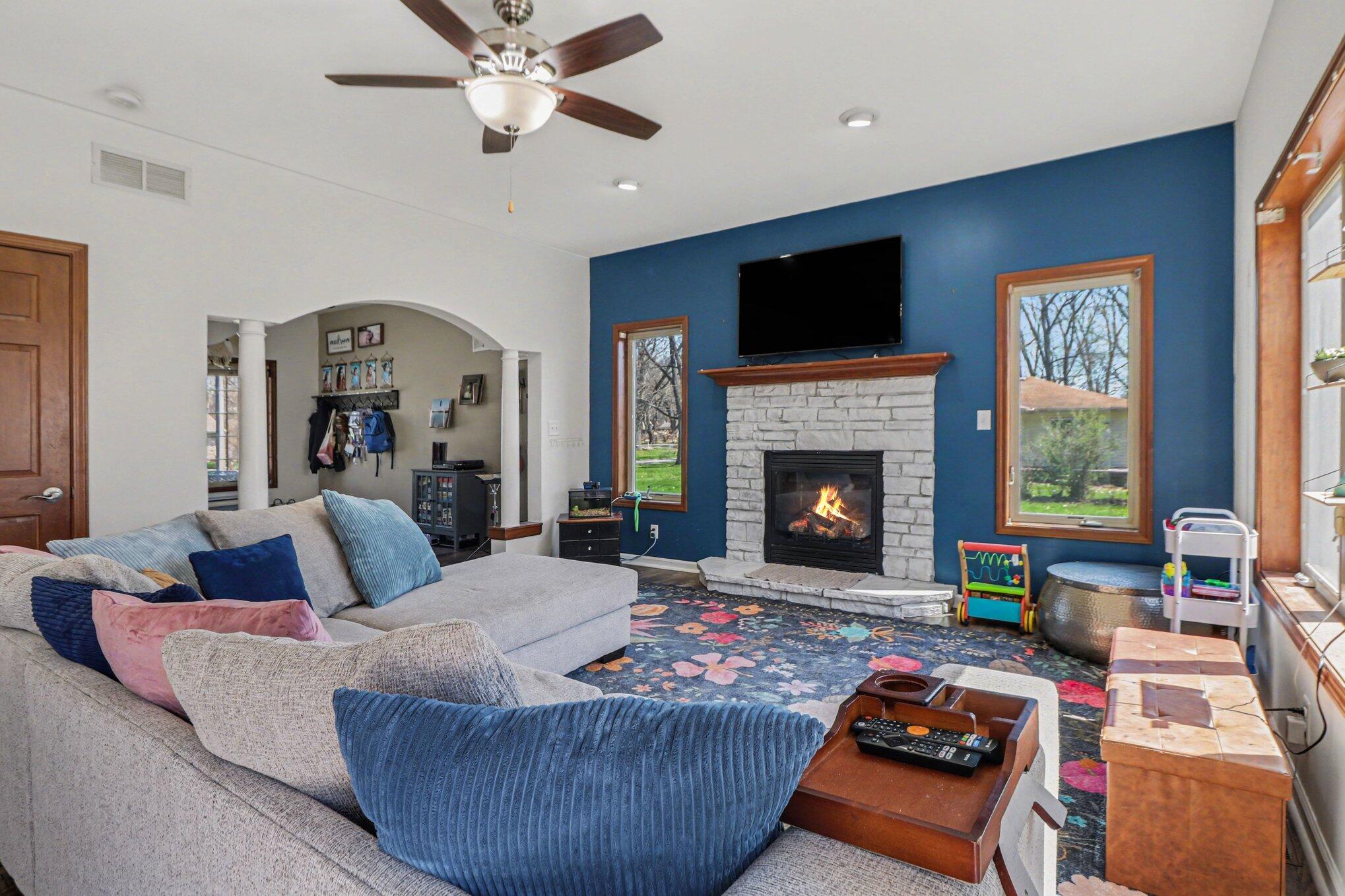 190 East Mekeland Road Chesterton, IN 46304 - Photo 10 of 29 a living room with furniture a fireplace and a flat screen tv