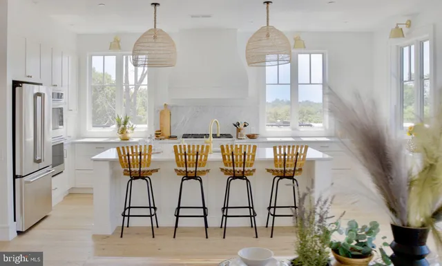 a dining room with furniture a chandelier and wooden floor