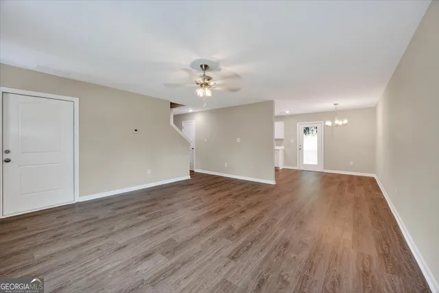 a view of an empty room and wooden floor
