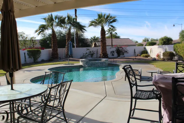 a view of a swimming pool with a table and chairs