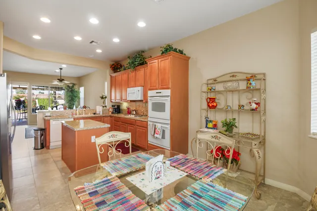 a dining room filled with lots of furniture and appliances
