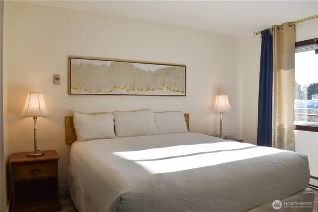 a bedroom with a bed and a lamp