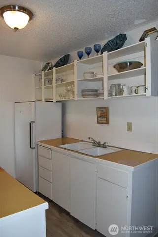 a kitchen with a cabinets and wooden floor