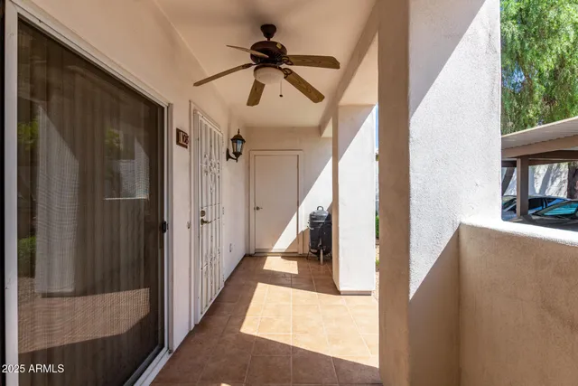 a view of staircase with lots of frames and white walls