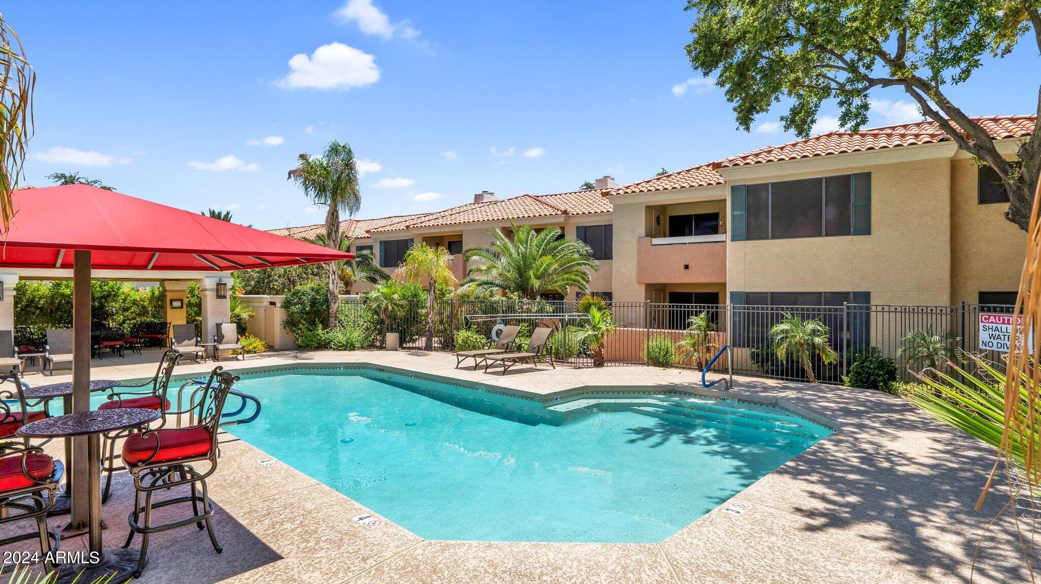 9990 North Scottsdale Road, Unit 1019 Paradise Valley, AZ 85253 - Photo 28 of 30 a view of a house with backyard sitting area and swimming pool