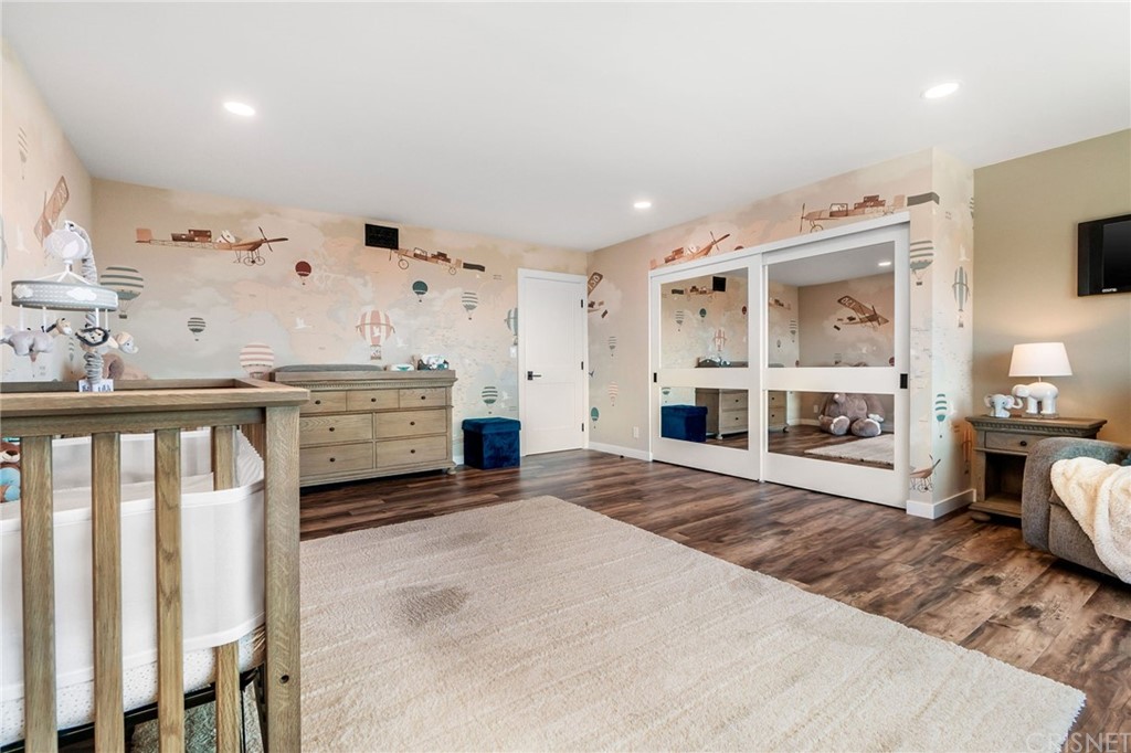 3105 Dona Sofia Drive Studio City, CA 91604 - Photo 33 of 45 a spacious bedroom with a bed and a fireplace