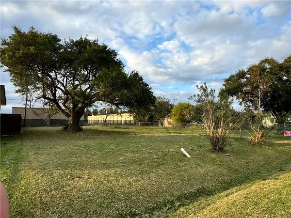 a view of outdoor space with playground and green space