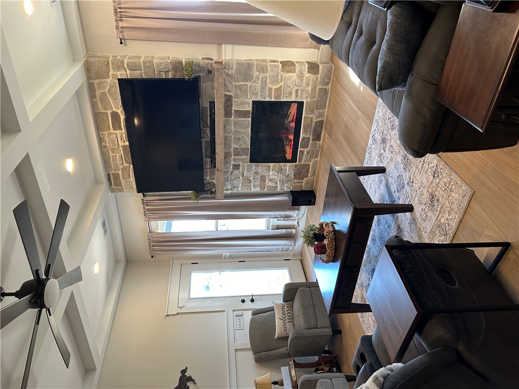 119 Dobbins Road Townville, SC 29689 - Photo 16 of 21 This living room features a fireplace and wood flooring.