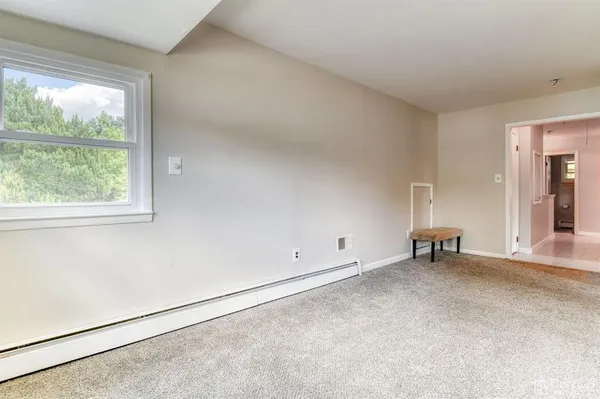 an empty room with windows and closet