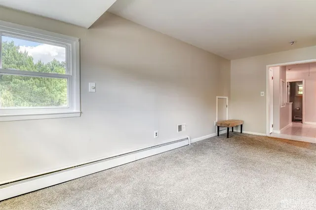 an empty room with windows and closet