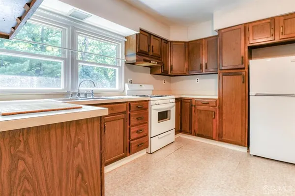 a kitchen with stainless steel appliances granite countertop a stove a sink dishwasher and a refrigerator