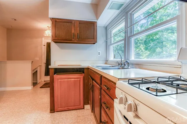 a kitchen with stainless steel appliances granite countertop a sink stove and a refrigerator