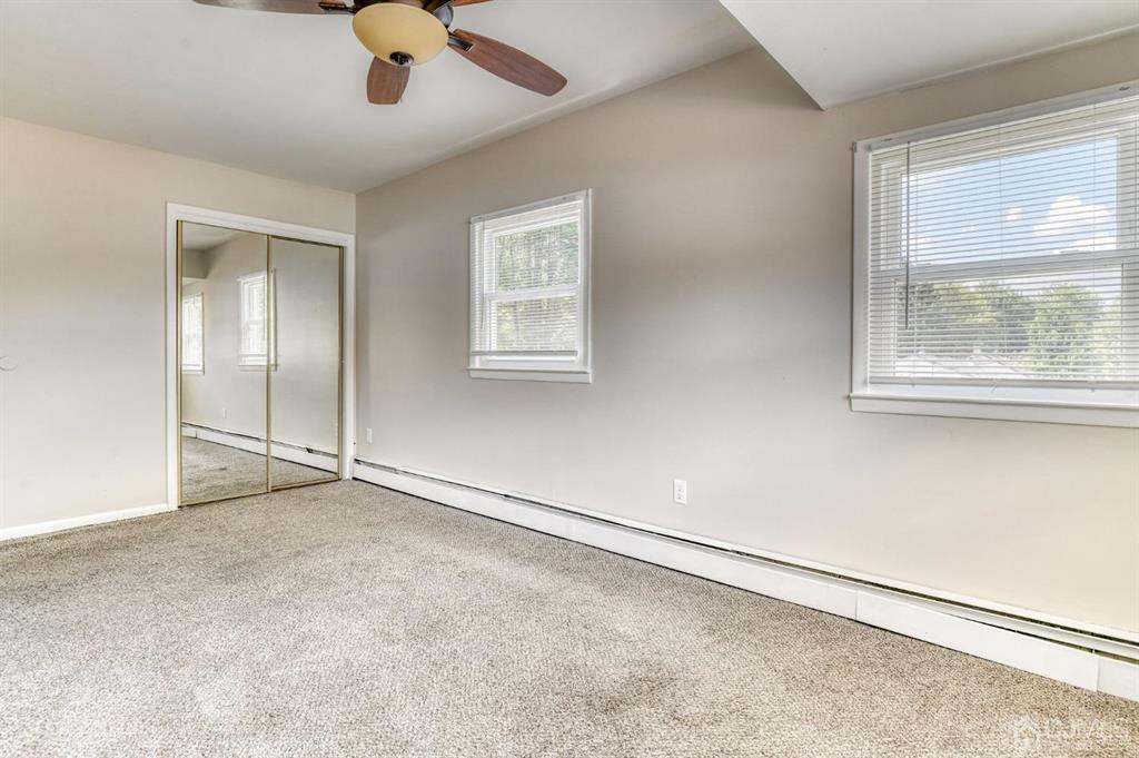22 Baker Drive Helmetta, NJ 08828 - Photo 10 of 15 an empty room with a window and a ceiling fan