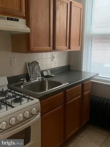 a kitchen with a stove and a sink