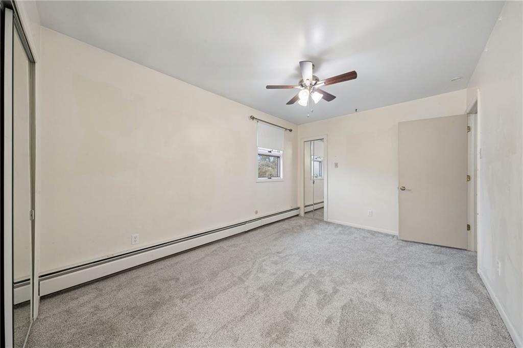 255 Poplar Street Monroeville, PA 15146 - Photo 26 of 50 an empty room with chandelier fan and windows
