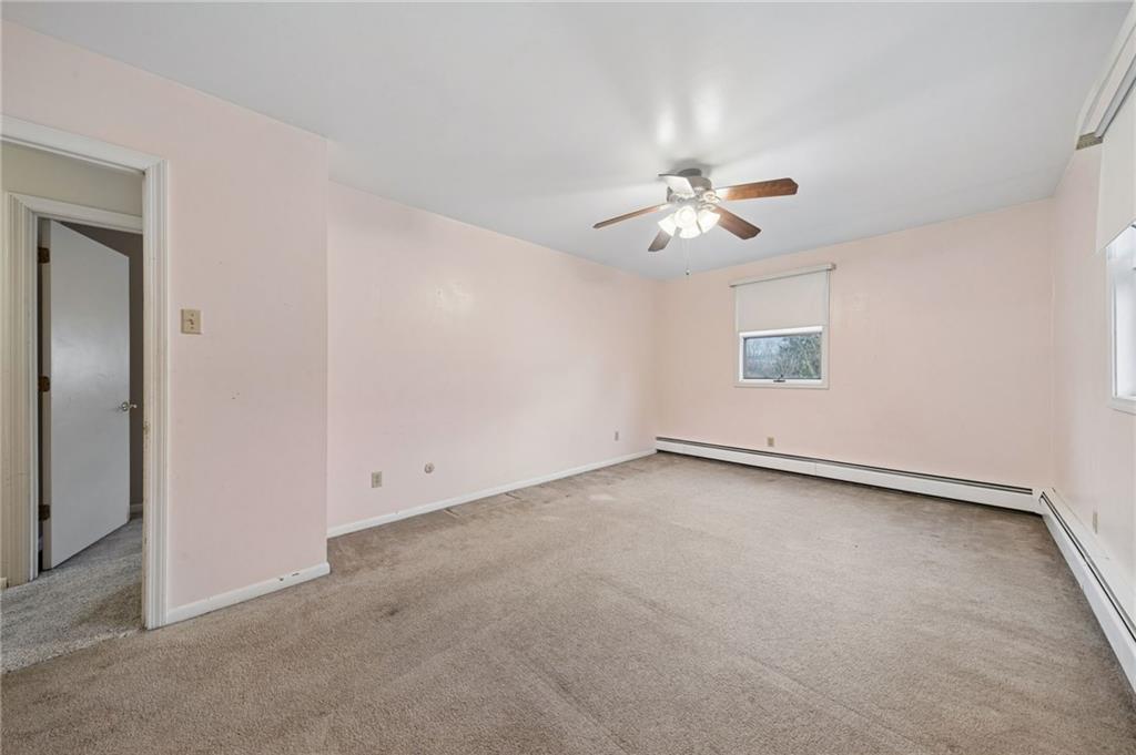 255 Poplar Street Monroeville, PA 15146 - Photo 27 of 50 an empty room with a window and a ceiling fan