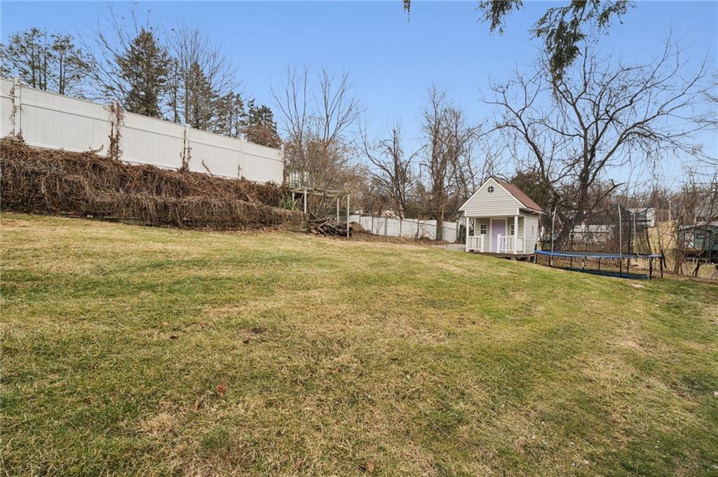 255 Poplar Street Monroeville, PA 15146 - Photo 38 of 44 Back yard with playhouse and trampoline.