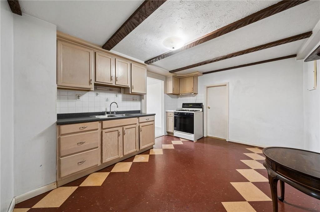 255 Poplar Street Monroeville, PA 15146 - Photo 39 of 50 a kitchen with granite countertop a stove cabinets and a sink