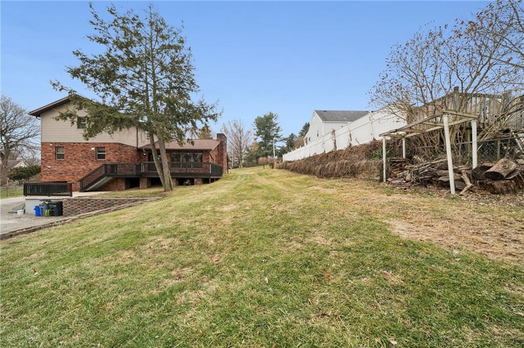 255 Poplar Street Monroeville, PA 15146 - Photo 45 of 50 a view of a backyard with table and chairs and a large tree